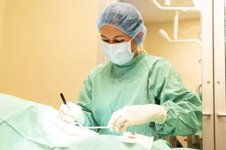 Person in scrubs performing surgery