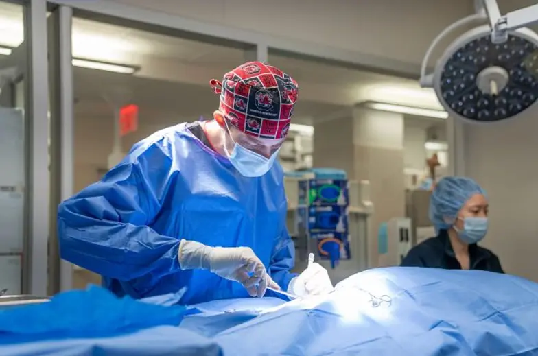Intern performing surgery