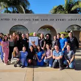 Consult team standing and kneeling in front of San Diego Humane Society