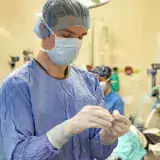 Person in scrubs with the surgery suite in the background