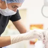 Veterinarian performing surgery on a small animal