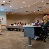 A veterinarian teaches a large room of students the specialties of community animal medicine