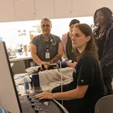 Three interns observing a doctor