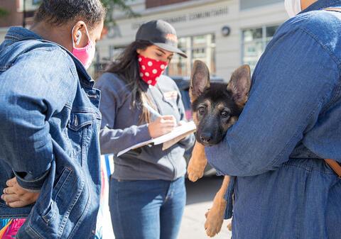 puppy in arms of owner at aspca clinic