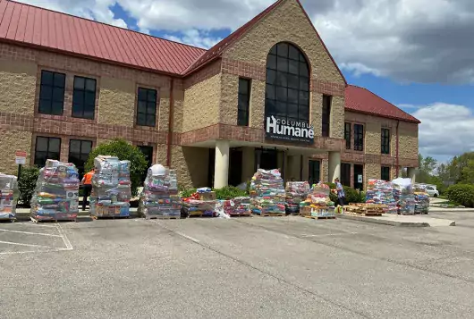 building with piles of bags of food for distribution
