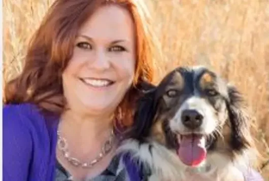 karen walsh holding a happy dog