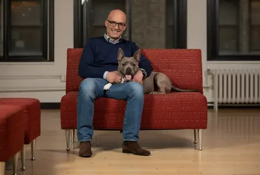 matt bershadker with happy grey dog