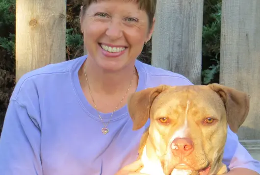 Dr. Brenda Griffin with a yellow dog