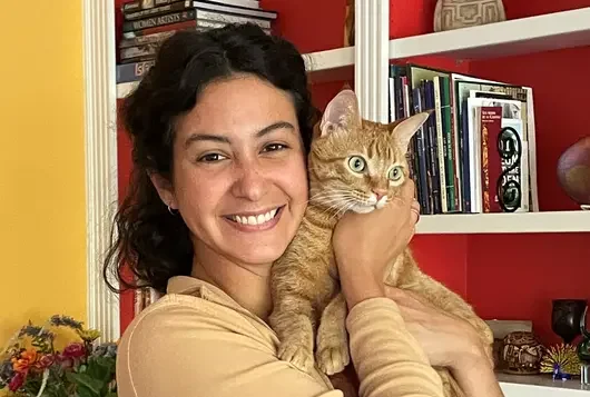 biana holding a happy orange cat