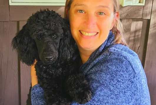 Photo of Dr. Miranda Workman holding a black dog