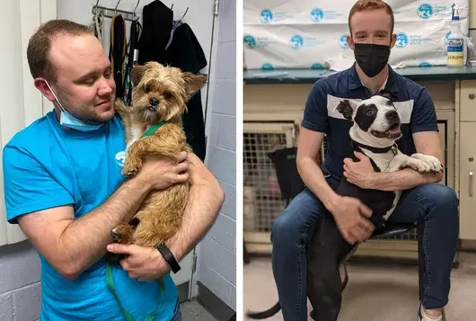 one man holding a small dog and another man supporting a larger dog