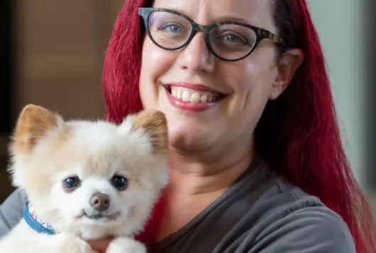 Photo of Deirdre Franklin holding a white dog