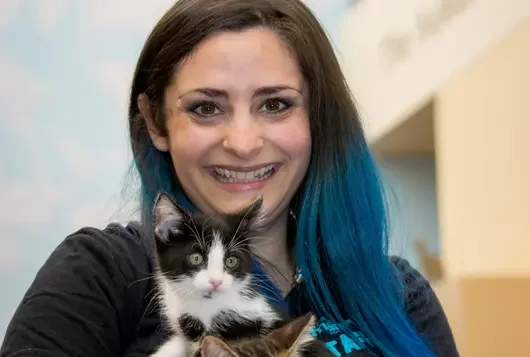 Photo of Juliette Nash holding two cats