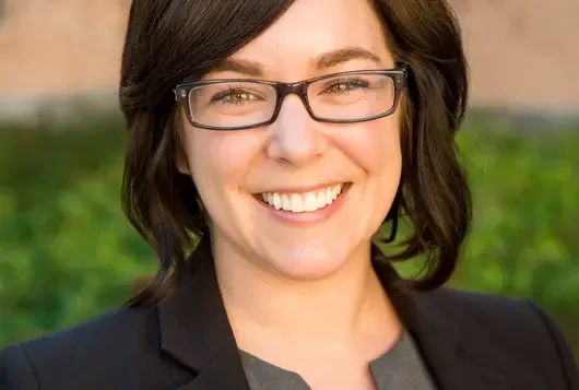Headshot of Julianna Tetlow against grass and trees