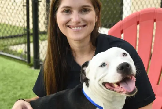 Photo of Leah Backo with white dog