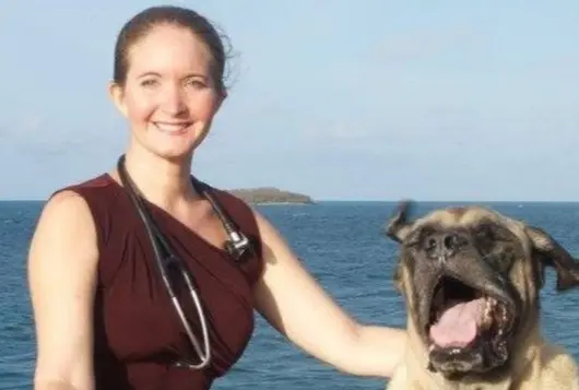 Photo of Dr. Emma Gordon with large brown dog