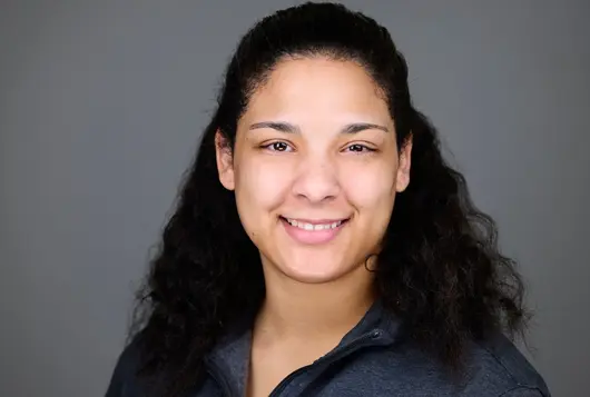 Headshot of Dr. Ashley with gray backdrop