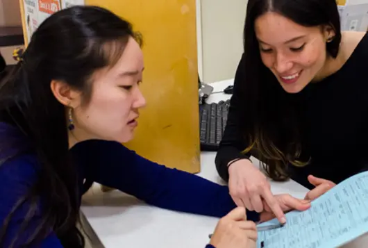 a shelter worker goes over paperwork with adopter 