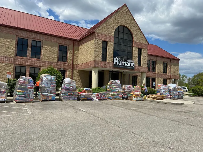 building with piles of bags of food for distribution