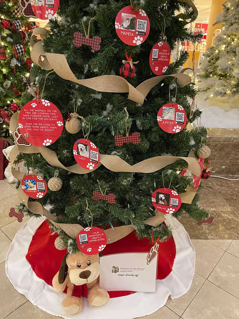 a decorated christmas tree with ornaments that represent shelter animals needing help