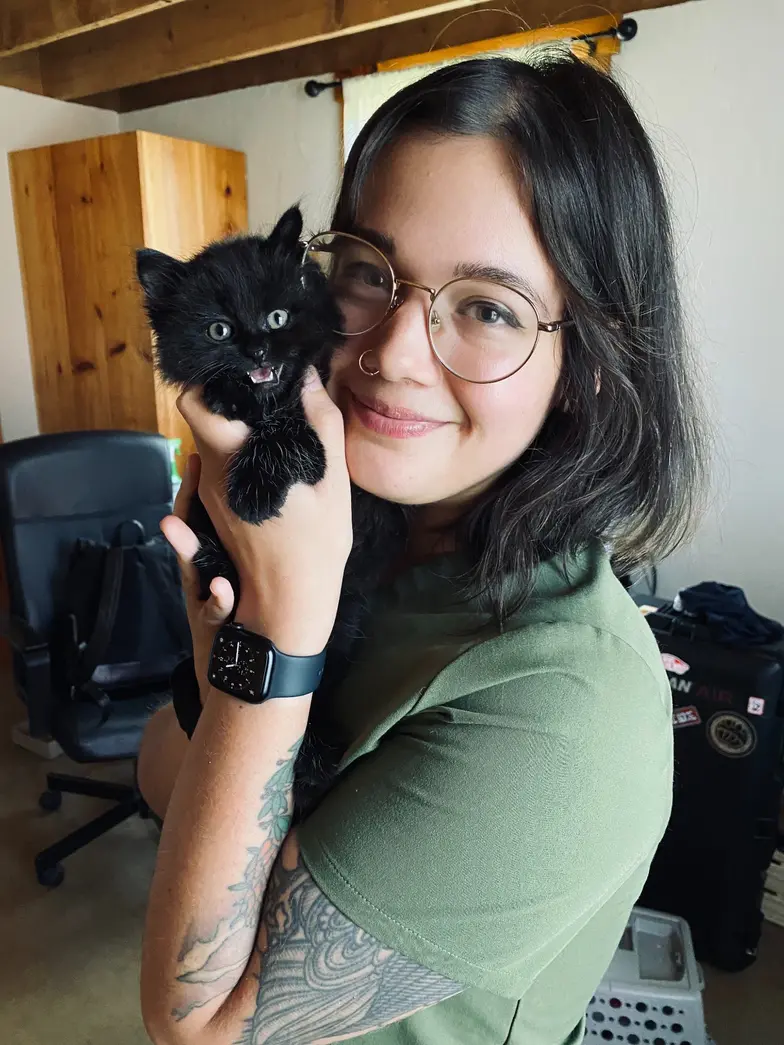 Woman holding a black cat