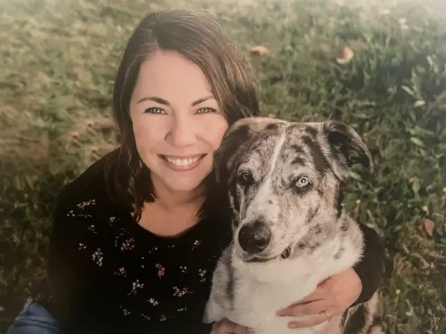 Woman with her arm around a dog