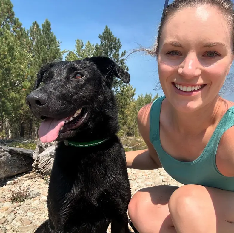 Photo of volunteer with black dog