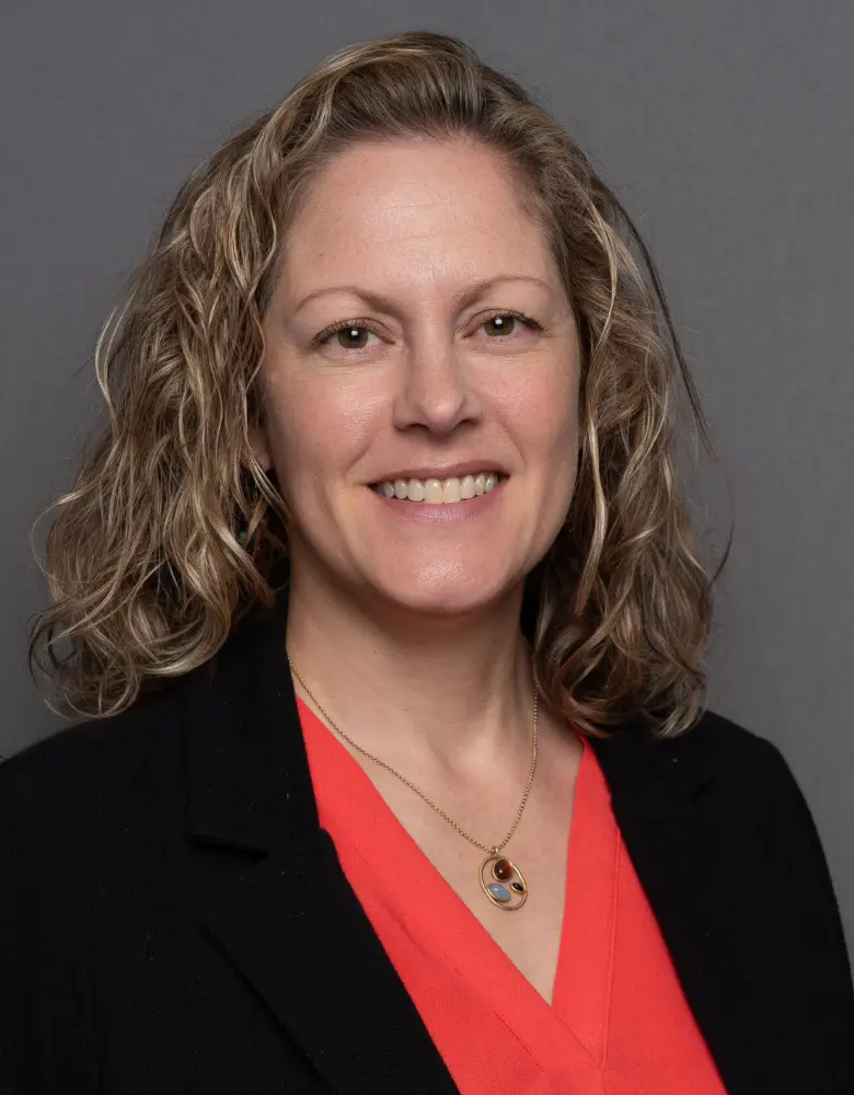 Photo of Elise Gingrich wearing a red shirt and a black blazer